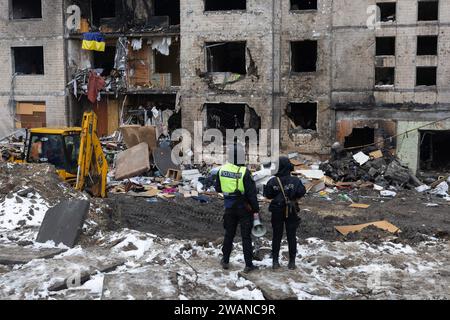 Kiev, Ukraine. 05 janvier 2024. Des policiers regardent un immeuble résidentiel endommagé par une attaque de missiles russes à Kiev. Au moins 27 personnes ont été hospitalisées et une femme âgée blessée est morte dans une ambulance après un incendie dans un bâtiment de plusieurs étages à la suite d'une attaque à la roquette à Kiev le 2 janvier 2024. (Photo Oleksii Chumachenko/SOPA Images/Sipa USA) crédit : SIPA USA/Alamy Live News Banque D'Images