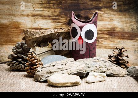 hibou en carton avec fond en bois et pierres Banque D'Images