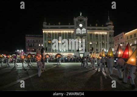 Dreikönigsingen und Glöcklerlauf am Rathausplatz in Gmunden, im oberösterreichischen Salzkammergut, am 05.01.2024. Sowohl das Dreikönigssingen als auch der Glöcklerlauf sind alte, eingeprägte Brauchtumsveranstaltungen im Salzkammergut in Österreich. Während des Glöcklerlaufs tragen junge Burschen prächtig geschmückte Laternenkappen mit meist lokalen Motiven am Kopf. Dabei wird durch laufen, springen und tanzen, mit an Gürteln der weiß Gekleideten angebrachten Glocken, entsprechend Lärm gemacht und dazu gesungen damit treiben die Glöckler in der letzten Rauhnacht der saison, dem 5,1. eines jede Banque D'Images