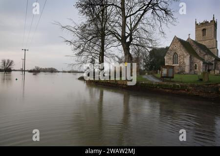 Huntingdon, Royaume-Uni. 06 janvier 2024. L'eau entoure l'église All Saints alors que la rivière Great Ouse éclate sur ses rives à Hartford. Les alertes aux inondations restent en place alors que les eaux continuent de monter dans l'est de l'Angleterre à la suite de la tempête Henk. Les rivières principales la rivière Great Ouse et la rivière Nene ont éclaté leurs rives et se sont déversées sur la campagne environnante et avec des drains pleins à pleine capacité, ils soutiennent dans les zones résidentielles. Crédit : SOPA Images Limited/Alamy Live News Banque D'Images