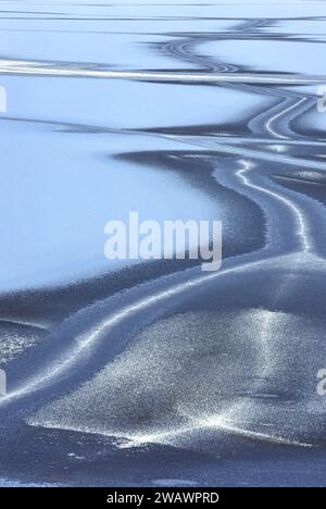 Hiver et motifs dans la glace d'un loch gelé ou d'un lac en Écosse Banque D'Images