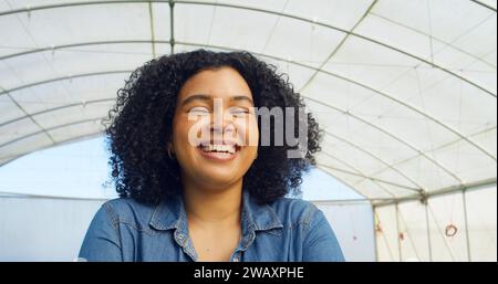 Gros plan portrait de femme fermière souriante debout dans la tente de serre Banque D'Images