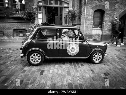 Une femme est assise à l'arrière d'une mini voiture britannique lors d'une visite des petites rues de Londres en Angleterre Banque D'Images