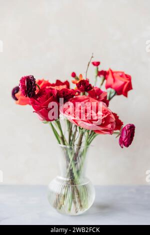 Arrangement floral rouge avec pivoines, roses, ranunculus et œillets Banque D'Images