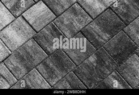 Fond de route pavée en béton gris foncé, motif de dalles de pavage, noir et blanc Banque D'Images