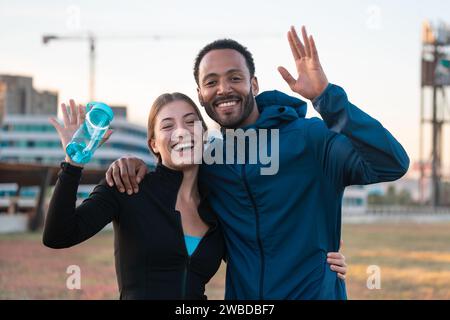 Portrait heureux jeune couple prêt à faire de l'exercice à l'extérieur. Banque D'Images