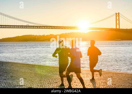 Lisbonne, Portugal. Joggeurs tôt le matin au bord de la rivière Targus. Un homme vérifiant l'heure. Banque D'Images