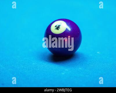 Gros plan de boules de billard colorées sur la table de billard bleue à la lumière du jour Banque D'Images