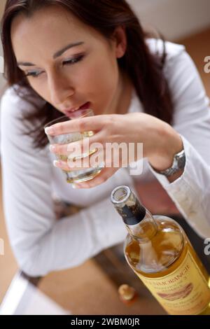 Femme buvant un verre de Whisky Banque D'Images