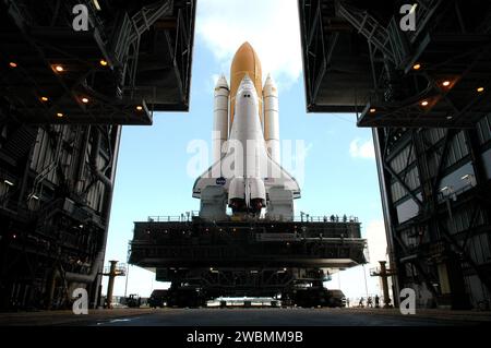 CENTRE SPATIAL KENNEDY, FLA. - Encadrée dans les portes ouvertes du Vehicle Assembly Building (VAB) du Kennedy Space Center de la NASA, la navette spatiale Discovery rencontre la lumière du jour alors qu’elle entame son long et lent voyage vers la plateforme de lancement 39B. La première motion a eu lieu à 2 04 h HAE. La navette comprend l'orbiteur, le réservoir externe (et) et les boosters à fusée solide jumeaux (SRB). La navette spatiale repose sur la plate-forme de lanceur mobile, qui est déplacée par le Crawler-transporter en dessous. Le Crawler mesure 20 pieds de haut, 131 pieds de long et 114 pieds de large. Il se déplace sur huit pistes, chacune contenant 57 chaussures, ou crampons, pesant Banque D'Images