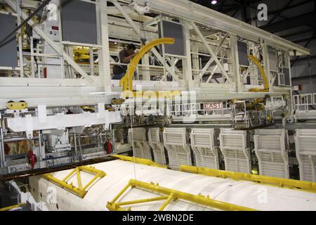 CAP CANAVERAL, Floride. – Dans l’Orbiter Processing Facility-1 du Kennedy Space Center de la NASA en Floride, un technicien de l’Alliance spatiale unie se prépare à ouvrir les portes de la baie de charge utile de la navette spatiale Atlantis avec l’aide des strongbacks jaunes attachés aux portes. Les Strongbacks sont utilisés pour soutenir et actionner les portes lorsque la navette n'est pas dans l'espace. Le travail fait partie du processus de transition et de retrait de la navette Atlantis dans le cadre du Programme de la navette spatiale. Une inauguration a eu lieu le 18 janvier pour la future maison d'Atlantis -- une salle d'exposition de 65 000 pieds carrés dans Shuttle Plaza à l'espace Kennedy Banque D'Images