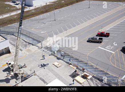 CAP CANAVERAL, Floride. – Les travailleurs utilisent une grue pour installer une nouvelle antenne de télémétrie parabolique et une nouvelle caméra de suivi sur le toit du Launch Control Center, ou LCC, dans le complexe de lancement 39 du Kennedy Space Center de la NASA en Floride. Ce système d'antenne et de caméra est le premier des trois systèmes qui seront installés sur le toit du LCC pour la station de radiofréquence et de télémétrie RFTS, qui sera utilisé pour surveiller les communications radiofréquence d'un lanceur au niveau de la rampe de lancement 39a ou B ainsi que pour fournir un relais radiofréquence pour un lanceur dans le bâtiment de montage des véhicules. Le RFTS remplace l'ère de la navette Banque D'Images