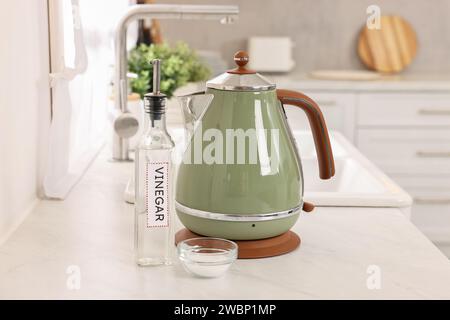 Nettoyage de la bouilloire électrique. Bouteille de vinaigre et bicarbonate de soude sur le comptoir dans la cuisine Banque D'Images