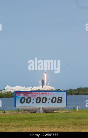 Avec une vue du compte à rebours du site de presse au premier plan, une fusée SpaceX Falcon 9 et un vaisseau spatial Crew Dragon décollent du Launch Complex 39a au Kennedy Space Center de la NASA en Floride le 30 mai 2020, transport des astronautes de la NASA Robert Behnken et Douglas Hurley vers la Station spatiale internationale pour la mission SpaceX Demo-2 de l’agence. Le décollage a eu lieu à 3:22 h HAE. Behnken et Hurley sont les premiers astronautes à se lancer du sol américain vers la station spatiale depuis la fin du programme de la navette spatiale en 2011. Faisant partie du programme commercial Crew de la NASA, il s’agira du dernier test en vol de SpaceX Banque D'Images