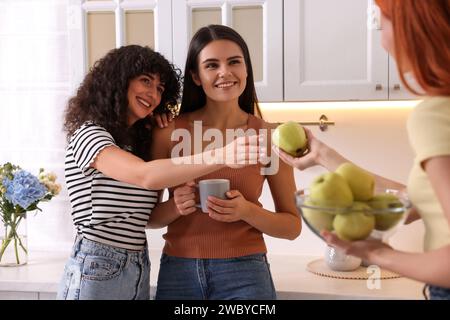 Heureux jeunes amis passant du temps ensemble dans la cuisine Banque D'Images