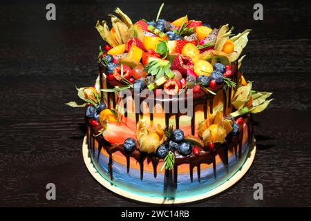 Délicieux gâteau aux fruits pour enfants avec fraises fraîches, framboises, myrtilles, groseilles, kiwi, la grenade. Banque D'Images