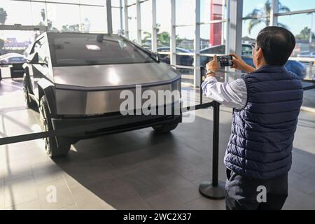 Les gens regardent un Cybertruck Tesla exposé chez un concessionnaire Tesla, vendredi 24 novembre 2023, à Buena Park, CA. (Dylan Stewart/image du sport) Banque D'Images