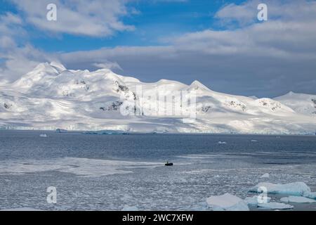 Zodiac naviguant à travers les eaux glacées de Neko, port, Antarctique, vue rapprochée des icebergs au sol se reflétant sur les eaux environnantes Banque D'Images