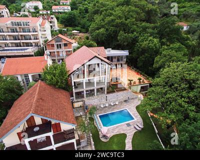 Villa de trois étages avec piscine et terrasses dans un jardin verdoyant. Drone Banque D'Images