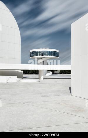 Photographie longue exposition avec nuages mobiles de la tour du Centre moderne Niemeyer à Aviles, Asturies, Espagne. Banque D'Images