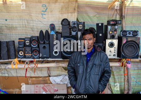 Jaynagar, Inde. 15 janvier 2024. Un vendeur de ferraille électronique se tient devant des haut-parleurs usagés à l'intérieur d'une foire de ferraille au Bengale occidental. Les habitants de Mathurapur Bengale occidental, en Inde, ont observé une bonne pratique de gestion des déchets en organisant une sorte de foire, la «Bhanga Mela» (Une foire des articles de rebut), où ils exposent des objets ménagers usagés et abandonnés à la vente. Des milliers de personnes viennent ici pour acheter ces produits de rebut ou des biens d'occasion pour les utiliser dans leurs maisons. (Photo de JIT Chattopadhyay/SOPA Images/Sipa USA) crédit : SIPA USA/Alamy Live News Banque D'Images