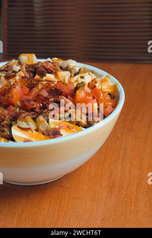 image verticale pour le site web et les réseaux sociaux des restaurants, de salade avec oeuf, bacon et légumes dans un bol en plastique sur la table, espace copie Banque D'Images