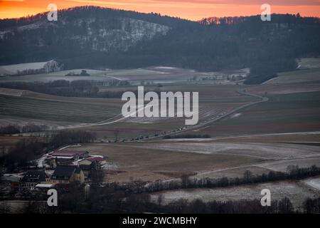 Bad Staffelstein, Allemagne. 16 janvier 2024. Les tracteurs empruntent une route de campagne en direction de Kloster Banz. L'Association des agriculteurs bavarois organise une manifestation des agriculteurs au début de la conférence d'hiver du groupe parlementaire CSU. Crédit : Daniel Vogl/dpa/Alamy Live News Banque D'Images