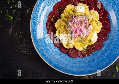 Salade épicée de hareng, betteraves, pommes de terre, cornichons et oignons rouges. Manger sainement. Vue de dessus Banque D'Images