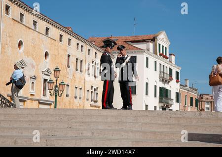 Venise Italie Mai 11 2022 ; deux carabiniers de police debout en uniforme sur la destination touristique populaire Banque D'Images