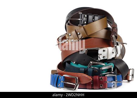 Vue de diverses ceintures en cuir colorées empilées dans une pile. Isolé sur fond blanc Banque D'Images