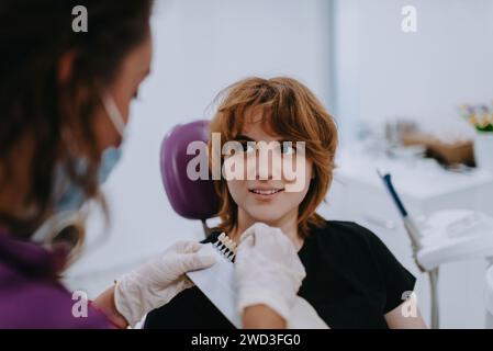 Un dentiste expérimente de nouvelles nuances de dents pour prothèses dans un cabinet dentaire, mettant en valeur la précision et l'innovation dans les soins dentaires Banque D'Images