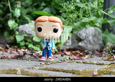 Funko Pop figurine d'action de l'adolescente Max Mayfield avec lecteur de cassette de la série télévisée Stranger Things. Feuilles vertes, route en pierre mousseline, jardin. Banque D'Images