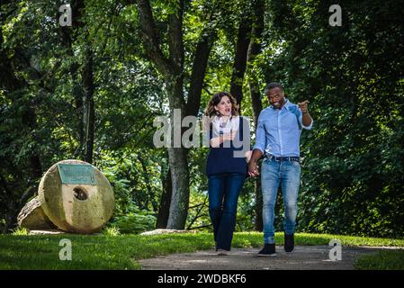 Femme caucasienne et homme afro-américain, marchant et parlant. Banque D'Images