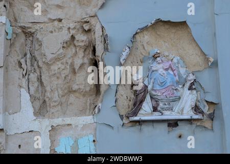 Art catholique un ikon en céramique bon marché de Christ enfant et Vierge Marie, une plaque murale, cassée sur un vieux bâtiment abandonné. Marsaxlokk, Malte, Île de Malte, 2024, années 2020 HOMER SYKES Banque D'Images