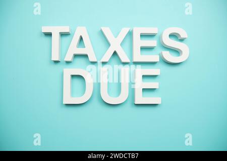 Taxes dues lettres de l'alphabet sur fond bleu Banque D'Images