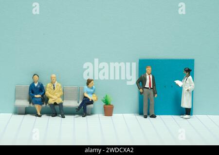 Photographie miniature de figurine de jouet de personnes minuscules. Une file d'attente à l'hôpital du patient pour rencontrer le médecin pour le bilan de santé médical. Image photo Banque D'Images