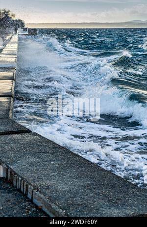 Les vagues s'écrasent sur la digue de la mer à Alki Beach à West Seattle, Washington. Banque D'Images