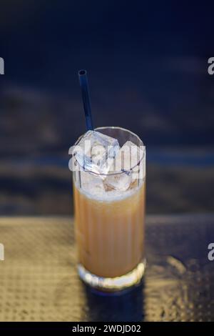 caucasien jeune barista aux cheveux rouges frais mélangeant un cocktail dans le shaker avec de l'énergie à l'extérieur dans un événement privé en hiver Banque D'Images