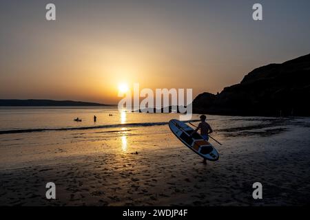 Surfeur sur la plage de Pwllgwaelod et Dinas Head sur la Wild Atlantic Coast du Pembrokeshire au pays de Galles, Royaume-Uni Banque D'Images