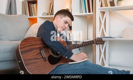 Chanson écriture musique compositeur guitare homme mélodie maison Banque D'Images