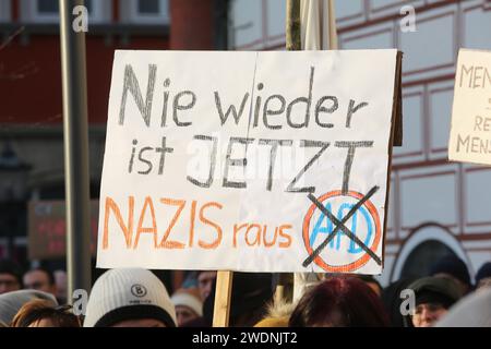 Coburg, Allemagne. 21 janvier 2024. Une pancarte indiquant «Nazis out» et «Never again means now» est maintenue en hauteur lors d'une manifestation. Des manifestants et des organisations telles que les Verts et Fridays for future se rassemblent pour protester contre la réunion de droite qui s'est tenue récemment près de Potsdam. Des membres de l’AFD ont participé à la réunion et des plans ont été discutés pour expulser les citoyens qui n’ont pas réussi à s’intégrer à la vie en Allemagne. Crédit : SOPA Images Limited/Alamy Live News Banque D'Images