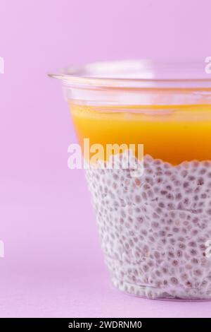 dessert with cream cheese, chia seeds and mango in a clear glass Banque D'Images