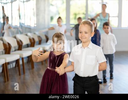 Tween filles ad garçons dansant la danse partenaire lente pendant l'événement festif Banque D'Images