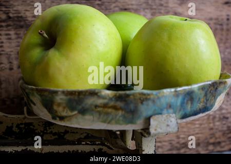 pommes vertes et rouges sur une échelle et fond en bois, style rétro - vue de côté. Banque D'Images