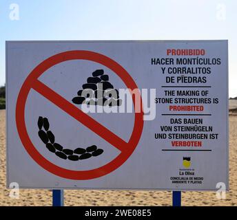 Panneau interdisant la construction de tours en pierre sur la plage, multilingue, Enlish, espagnol, allemand. Fuerteventura, Îles Canaries. Prise en novembre 2023 Banque D'Images