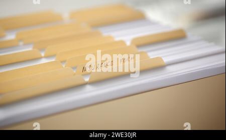 Dossiers jaune avec des étiquettes et du papier dans une rangée Banque D'Images