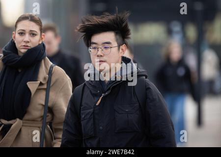 Londres, Royaume-Uni. 22 janvier 2024. Un homme aux cheveux balayés par le vent traverse Waterloo Bridge à Londres. Pendant la tempête Isha, les vols et les trains ont été annulés, et les avertissements de danger pour la vie restent en place avec un risque de tornades possibles dans certaines parties du pays. Crédit : SOPA Images Limited/Alamy Live News Banque D'Images