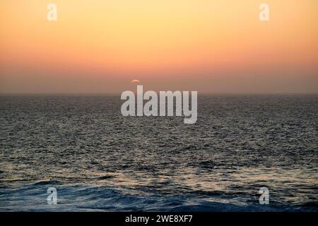 soleil couchant sur l'atlantique pendant la tempête de sable calima comme on le voit au large de la côte ouest de lanzarote îles canaries espagne Banque D'Images