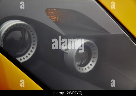 Détail de conception de phare de voiture moderne avec accents jaunes, vue rapprochée Banque D'Images
