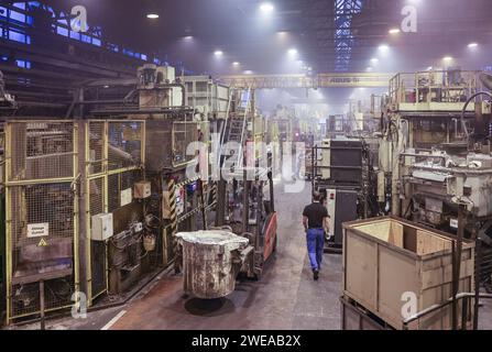 Annaberg Buchholz, Allemagne. 24 janvier 2024. Un employé transporte de l’aluminium fondu par l’intermédiaire de Handtmann Leichtmetallgießerei Annaberg GmbH. 328 employés produisent 60 000 tonnes de pièces moulées spéciales, principalement pour l'industrie automobile, sur le site des Monts du minerai. Fondée en 1926 en tant que fonderie DKW, des pièces pour motos MZ ont été fabriquées ici à l'époque de la RDA. Après la réunification, la société a été reprise par le groupe Handtmann de Biberach et a continué à s'étendre. Crédit : Jan Woitas/dpa/Alamy Live News Banque D'Images